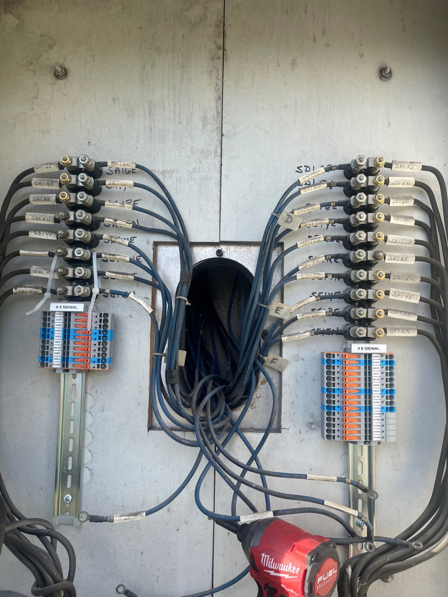 This image shows a combination of old-school AAR terminals with gold nuts and newer DIN Rail molded case terminal blocks. The orange switches on the newer products make it easy to spot any disconnects. (Image courtesy of WAGO)