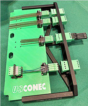 US Conec showed a high-signal density blind-mate optical backplane interconnect system using their MMC optical connector family.