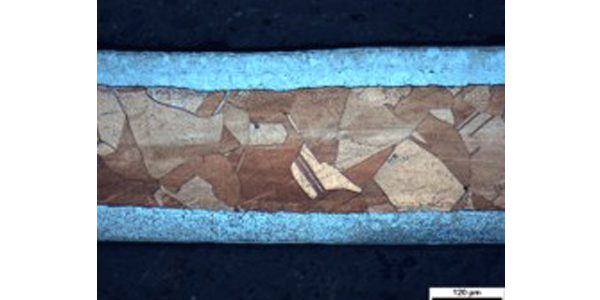 Micrograph of a cross section of clad showing discrete layers.
